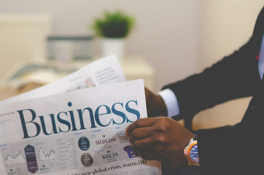 Reading the business section of a newspaper
